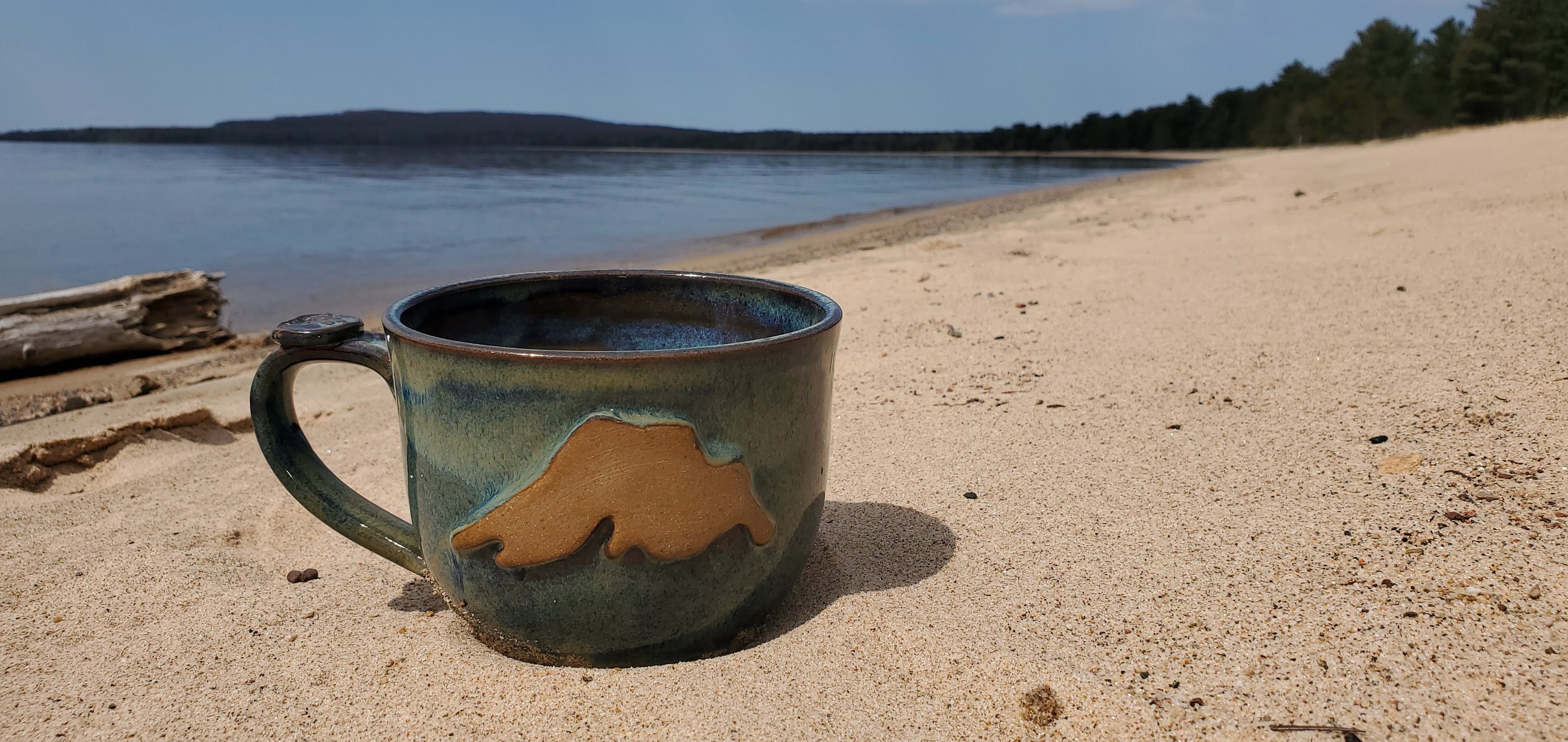 Green Cabin Pottery Mug on the beach